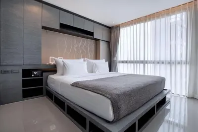 a bedroom with a large bed and a window at Enjoy Tropical Bliss in Kamala Suite CTG L704, Top Facilities, near FantaSea & Café Del Mar Beach Club in Kamala Beach