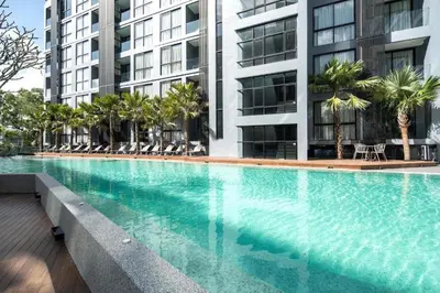 a large swimming pool in front of a building at Enjoy Tropical Bliss in Kamala Suite CTG L704, Top Facilities, near FantaSea & Café Del Mar Beach Club in Kamala Beach