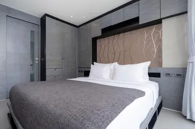 a bedroom with a large bed with white pillows at Enjoy Tropical Bliss in Kamala Suite CTG L704, Top Facilities, near FantaSea & Café Del Mar Beach Club in Kamala Beach