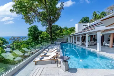 an exterior view of a house with a swimming pool at Villa Amankara in Phuket Town