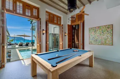 a pool table in the middle of a room with a pool table at Villa Amankara in Phuket Town