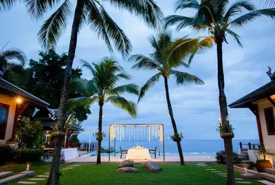 a wedding set up in a yard with palm trees at Villa Talaefun - Luxury Oceanfront Fully Serviced in Kamala Beach