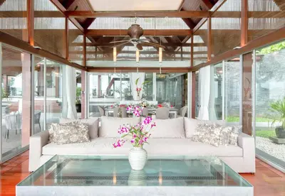 a living room with a white couch and a glass table at Villa Laemsingh 2 Oceanfront Fully Serviced in Surin Beach