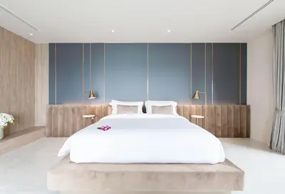 a bedroom with a white bed and blue walls at Villa Laemsingh 2 Oceanfront Fully Serviced in Surin Beach