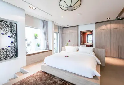 a bedroom with a large white bed and a window at Villa Laemsingh 2 Oceanfront Fully Serviced in Surin Beach