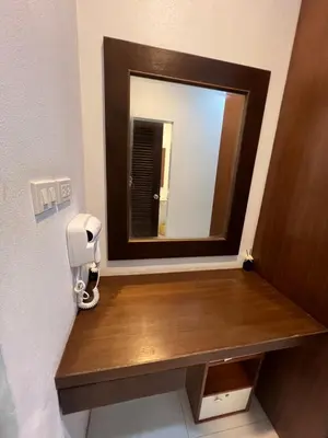 a bathroom with a mirror on a wooden counter at Nern khao Guesthouse in Kamala Beach