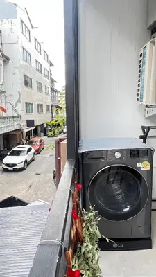 a washing machine sitting on the side of a building at Charming home patong in Patong Beach