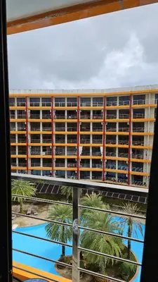 a view of a large building from a window at Cosy studio near the best beach on Phuket in Ban Mai Salae