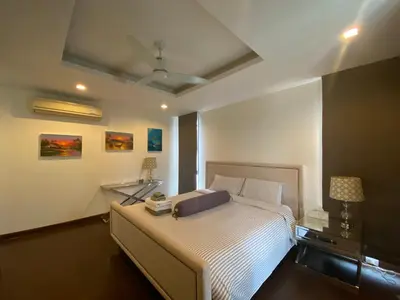 a bedroom with a bed and a ceiling fan at 4bdr Villa with gym and pool in Laguna #168 in Laguna Phuket