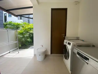 a washer and dryer in a room with a door at 4bdr Villa with gym and pool in Laguna #168 in Laguna Phuket