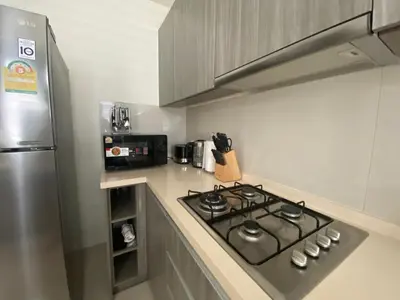 a kitchen with a stove and a refrigerator at 4bdr Villa with gym and pool in Laguna #168 in Laguna Phuket
