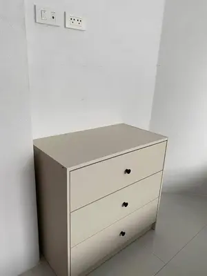 a white dresser in a room with a white wall at Family House in Bang Tao in Ban Thalat Choeng Thale