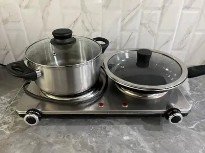 a pot and pans sitting on a stove at Family House in Bang Tao in Ban Thalat Choeng Thale