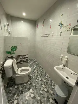 a bathroom with a toilet and a sink at Family House in Bang Tao in Ban Thalat Choeng Thale