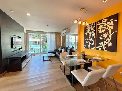 a living room with a dining table and a couch at 1 bedroom Suite Seaview In Kalim in Patong Beach