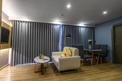 a living room with a chair and a table at View 2Bdr Lux Life Rawai in Rawai Beach