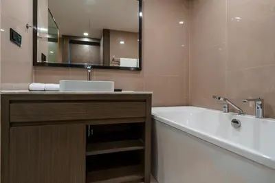 a bathroom with a tub and a sink and a mirror at View 2Bdr Lux Life Rawai in Rawai Beach