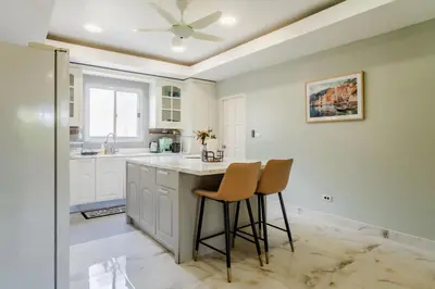 a kitchen with a counter and two stools at Flora 2 Bedroom HouseNear Naiharn - Rawai Beach in Rawai Beach