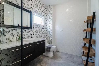 a bathroom with a toilet and a sink and a mirror at Flora 2 Bedroom HouseNear Naiharn - Rawai Beach in Rawai Beach