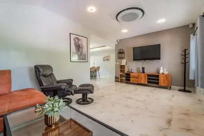 a living room with a couch and a tv at Flora 2 Bedroom HouseNear Naiharn - Rawai Beach in Rawai Beach