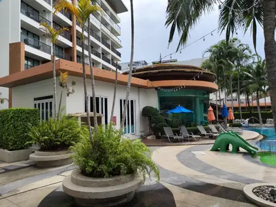 a swimming pool with a green slide in a resort at 7 Floor - Pool view Studio room at TBHR near Kata beach in Kata Beach