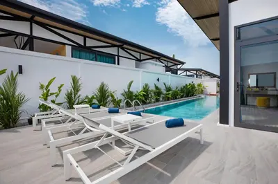 an outdoor patio with lounge chairs and a swimming pool at 3BR Villa Sunset Garden 12 - Private 18m Pool in Rawai in Rawai Beach