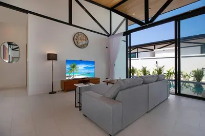 a living room with a couch and a flat screen tv at 3BR Villa Sunset Garden 12 - Private 18m Pool in Rawai in Rawai Beach