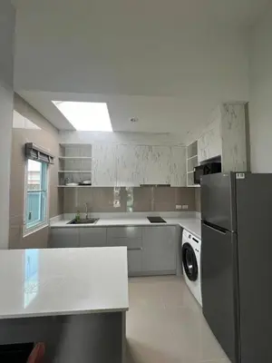 a white kitchen with a refrigerator and a sink at The Rich Villas Palai in Chalong