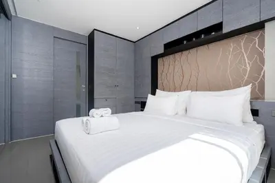 a large white bed with two towels on it at Tropics Hill View Apartment CTG L706 at Kamala Residence, Top Amenities, Close to the Beach and Fantasea in Kamala Beach