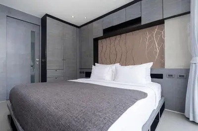 a bedroom with a large bed with white pillows at Green View Suite CTG P210 at Tropics Kamala Residence near Fantasea in Kamala Beach