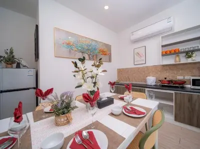 a kitchen with a table with chairs and a dining room at 4Luxury Pool Villa 4 Bedrooms Private Pool Kitchen in Ban Bang La