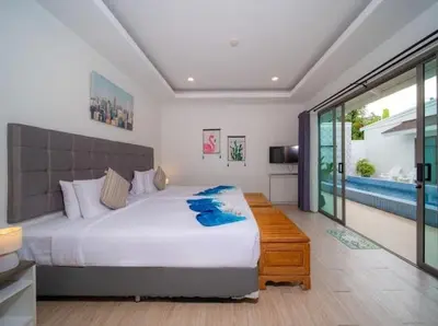 a bedroom with a large bed and a pool at 4Luxury Pool Villa 4 Bedrooms Private Pool Kitchen in Ban Bang La