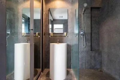 a bathroom with a shower and two white urinals at Tropics Kamala Hill View Studio CTG P613 near Beach and Fantasea in Kamala Beach