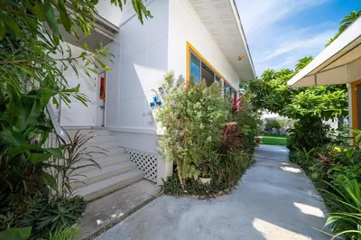 a white house with plants on the side of it at 2Exclusive 4BR Villa with Private Pool Kitchen Ideal for Families in Ban Bang La