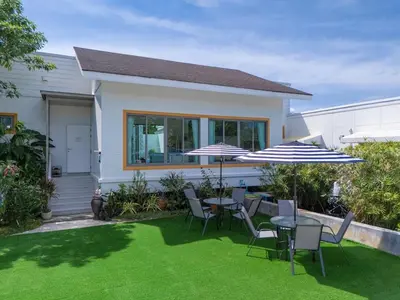 a patio with tables and chairs and umbrellas at 2Exclusive 4BR Villa with Private Pool Kitchen Ideal for Families in Ban Bang La