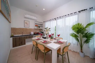 a kitchen and dining room with a table and chairs at 3Elegant 4BR Villa with Pool in Ban Bang La