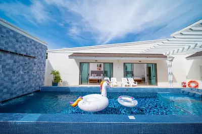 a swimming pool with two inflatable swans in a house at 3Elegant 4BR Villa with Pool in Ban Bang La