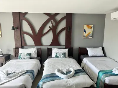 a room with two beds with a heart on them at Sparta beachfront patong in Patong Beach