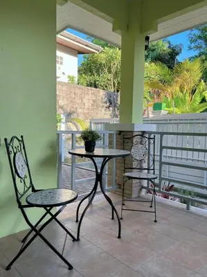 a patio with two chairs and a table on a porch at Home Tambon Bang tao 2BR Near Beach in Surin Beach