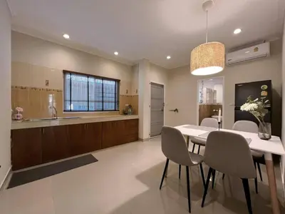 a kitchen and dining room with a table and chairs at Home Tambon Bang tao 2BR Near Beach in Surin Beach