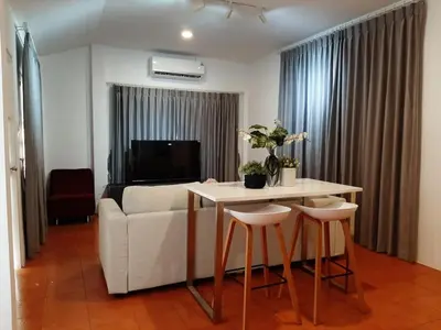 a living room with a table and a couch at Prime Hill Kathu Phuket D3 in Ban Ket Ho