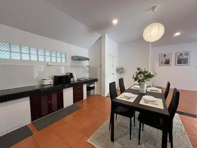 a kitchen and dining room with a table and chairs at Prime Hill Kathu Phuket D3 in Ban Ket Ho
