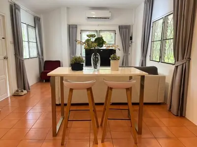 a table and two stools in a living room at Prime Hill Kathu Phuket D3 in Ban Ket Ho