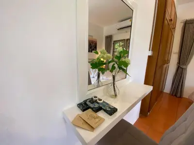 a room with a table with a mirror and a book at Prime Hill Kathu Phuket D3 in Ban Ket Ho