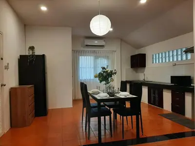 a kitchen with a table and chairs in a room at Prime Hill Kathu Phuket D3 in Ban Ket Ho
