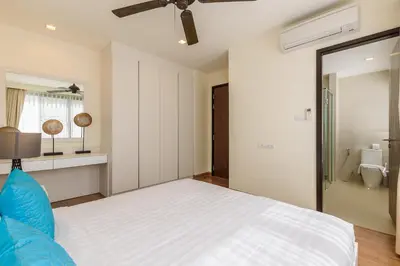 a bedroom with a white bed and a bathroom at Laguna Park Townhouse by Villacarte in Laguna Phuket