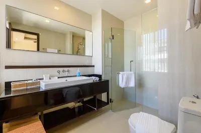 a bathroom with a sink and a mirror and a shower at Laguna Park Townhouse by Villacarte in Laguna Phuket