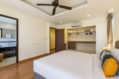 a bedroom with a bed and a ceiling fan at Laguna Park Townhouse by Villacarte in Laguna Phuket