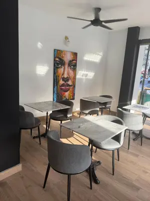 a room with tables and chairs and a painting at The little Mermaid in Patong Beach