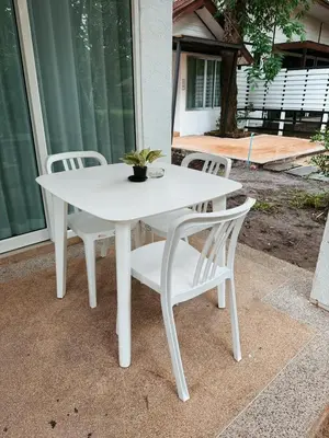 a white table and chairs on a patio at Green Haven Villas in Krabi town